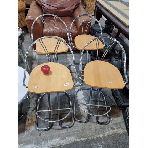 643 - A stylish set of four contemporary kitchen bar stools with maple seat and chrome frame.