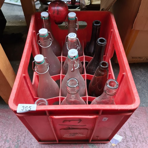 365 - A crate of 12 glass bottles including brown wine and clear water examples with stoppers.