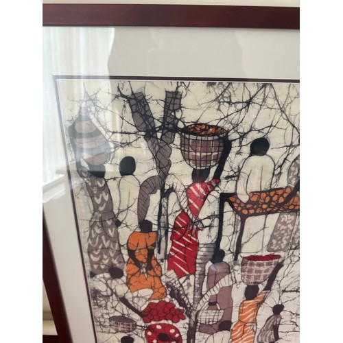 405 - A large signed African Batik, showing people doing daily chores, lovely colours. Nice quality frame ... 