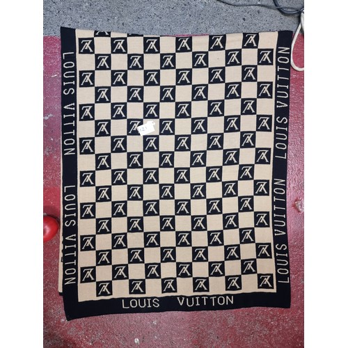 121 - A large  Louis Vuitton scarf featuring a monogram design in beige and black.