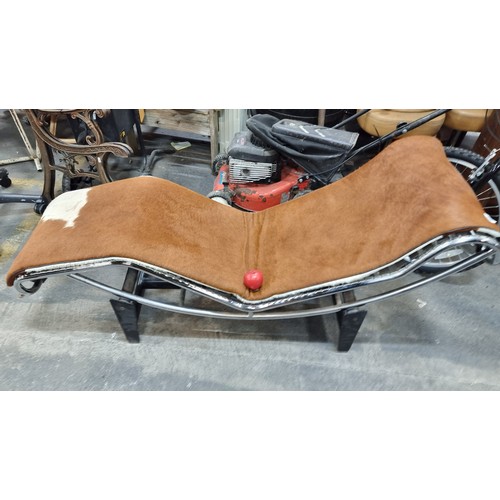 651 - Star Lot: An Iconic LC4 Le Corbusier cow hide lounge chair. Features a chrome tube frame to complete... 