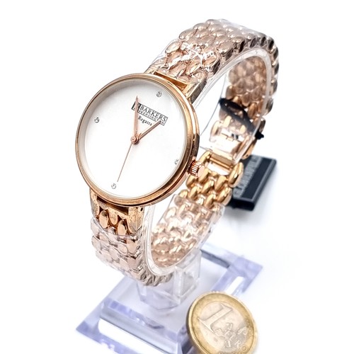 28 - A Barkers of Kensington Globenfeld quartz dress wristwatch with gold tone bracelet, watch in New con... 