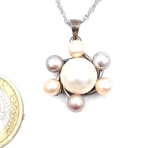 55 - A beautiful natural Fresh Water Pearl Pendant with Center Stone and 6 stone surround set with a brig... 