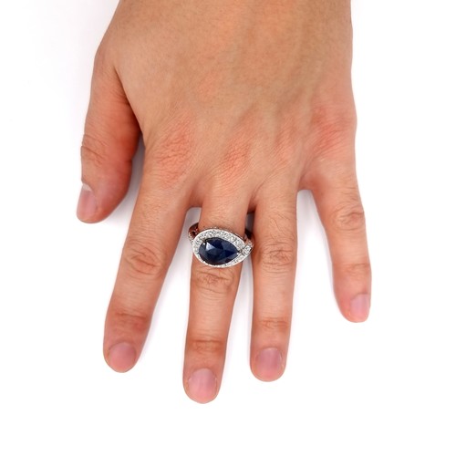 58 - A very unusual large natural Sapphire, in a tear drop form and surround with sparkling gem stones. F... 