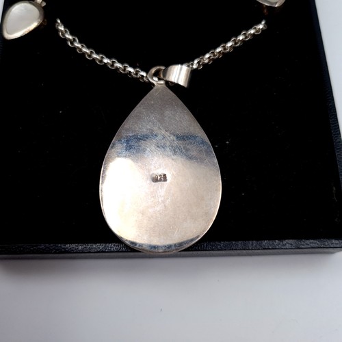 679 - A good quality sterling silver mother of pearl pendant necklace and chain together with matching stu... 