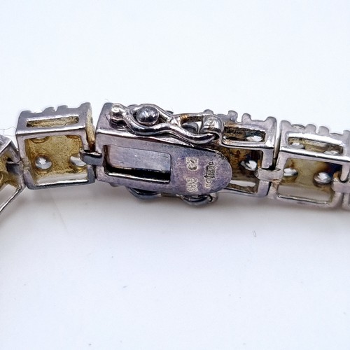 680 - A sterling silver two row gem set line tennis bracelet, weight 23 grams.