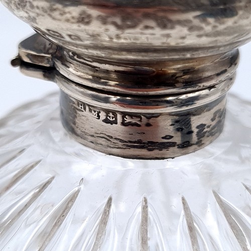 681 - An antique cut glass sterling silver topped perfume  bottle, hallmarked Birmingham. Lid set with att... 