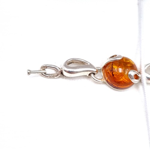 692 - An attractive example of an amber stone bracelet set in sterling silver.