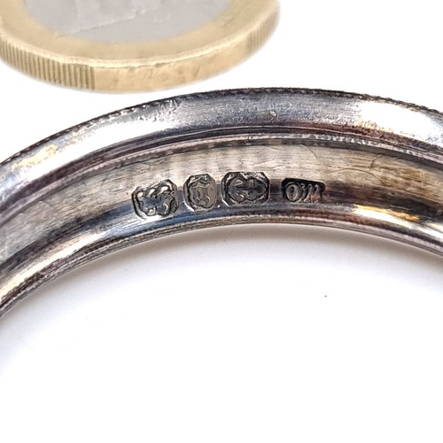 694 - Two sterling silver napkin rings with floral chased design, total weight 6.92 grams.