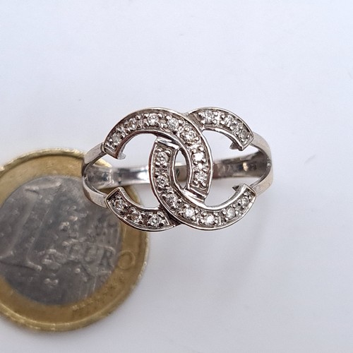 745 - Star Lot : A Chanel Style brilliant cut diamond dress ring set in 9K white gold (375), size S, weigh... 