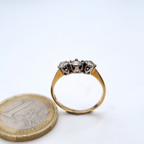 749 - Star Lot : A brilliant cut 3 stone diamond ring with crown setting, estimated weight .4cts, J colour... 