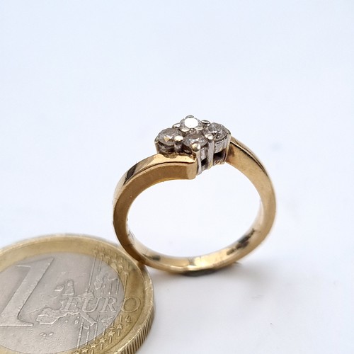 750 - Star Lot : A super pretty 9K gold brilliant cut four stone crossover ring, diamond weight .25cts, st... 