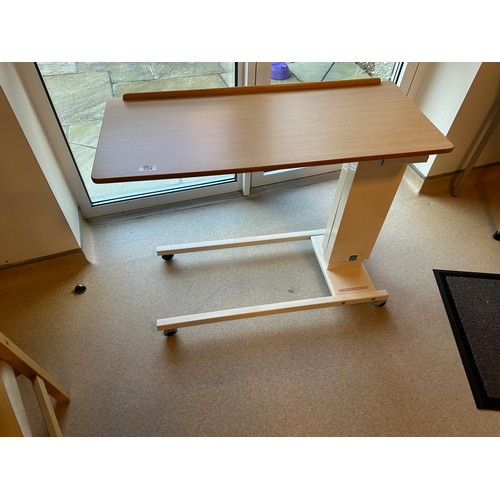 534 - A Commercial quality Sidhil Hospital bed Dinner table with wheels for sliding in and out.
There is o... 