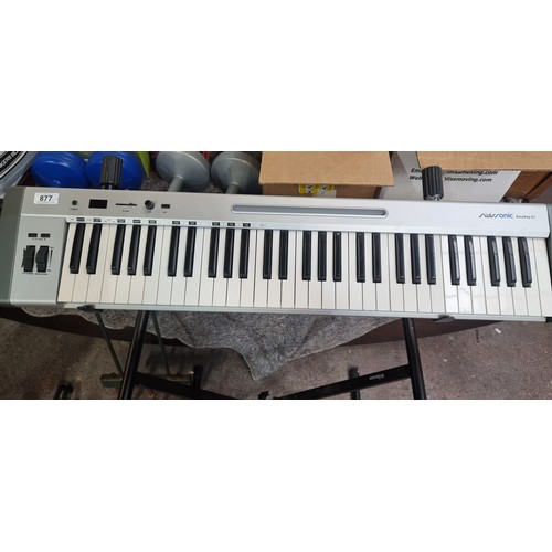 877 - A superb Swissonic Easykey 61 keyboard complete with stand. Features 61 Full-size velocity-sensitive... 