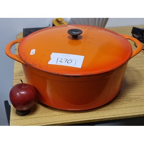 270 - A vintage Cousances (now known as Le Creuset) cast iron dutch oven. In a vibrant orange shade.