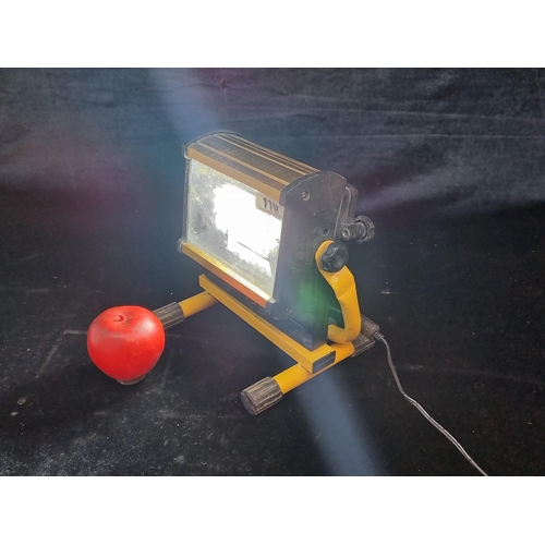 110 - A portable LED floodlight held on stand. Fully working. Regular plug.