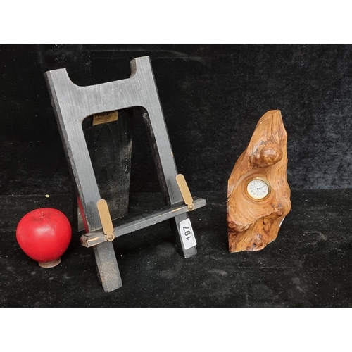 197 - Two items comprising of a smart wooden picture frame stand and a carved applewood mantle clock.