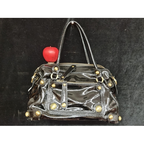 221 - A wonderful original Karen Millen genuine leather handbag adorned with brass accents including studs... 