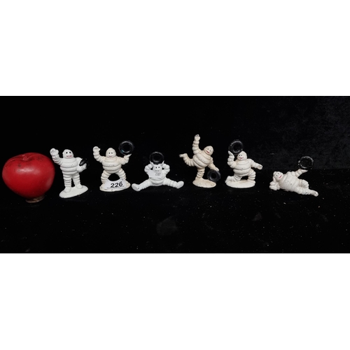 226 - A cheerful set of six cast metal Michelin Men figurines, in a variety of humorous poses.