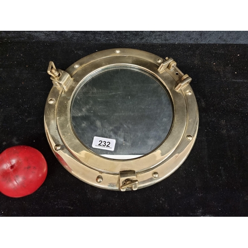 232 - A beautiful brass porthole mirror.