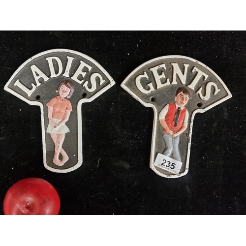 235 - A charming pair of cast metal bathroom wall plaques reading Ladies & Gents.