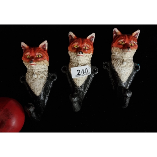 240 - A trio of heavy cast metal hooks if the form of gentlemanly foxes.