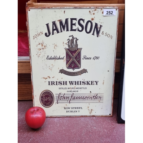 252 - A cast metal wall sign showing a vintage advertisement for Jameson Irish Whiskey.