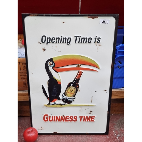 253 - A large metal wall advertising sign for Guinness featuring the famous Guinness Toucan character. 