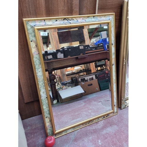 272 - A very chic beveled wall mirror, held in a gilt wooden frame with floral boarder.
MM: W64 x H85 cm