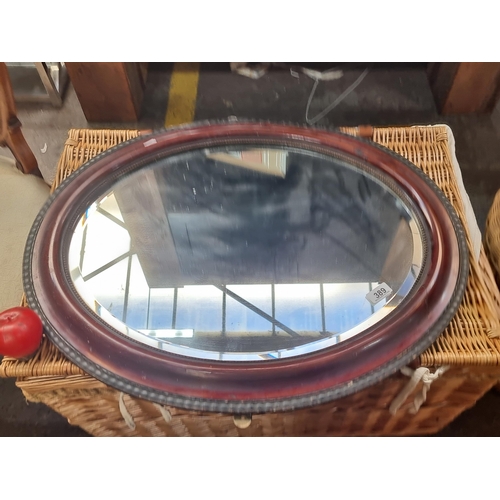 389 - A super vintage mahogany framed  bevelled oval mirror with beveled glass and bead detailing.