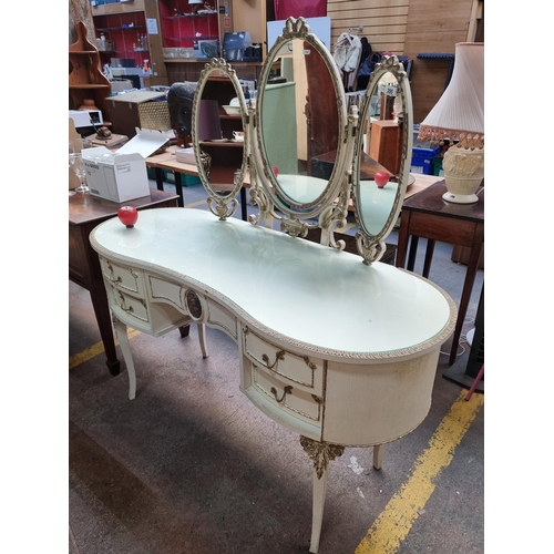 395 - Star Lot : A highly ornate French style kidney shape dressing table. Boasting gilt detailing in reli... 