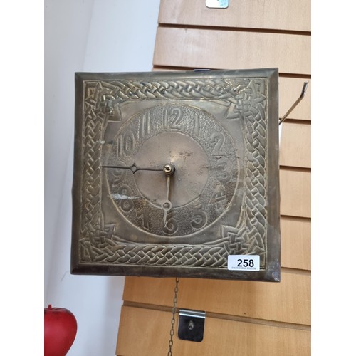 258 - An unusual vintage brass pendulum clock in the style of Margaret Gilmour. With a square face boastin... 