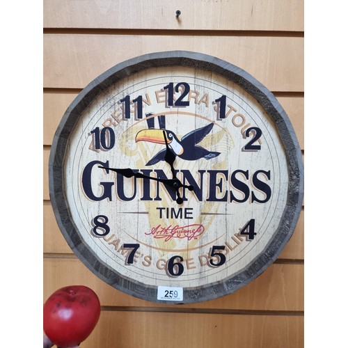 259 - A Guinness advertising barrel top wall clock.