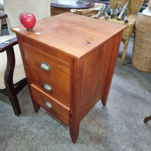 401 - A handsome cabinet with three drawers boasting domed metal cup handles.