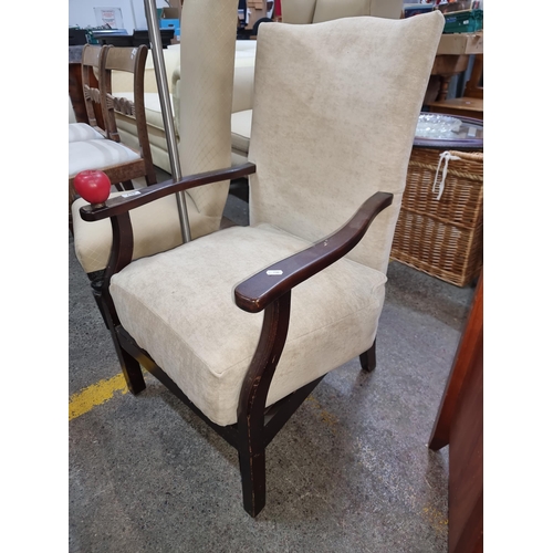 402 - A handsome vintage armchair featuring curved armrests, cream upholstery and spring seat base.