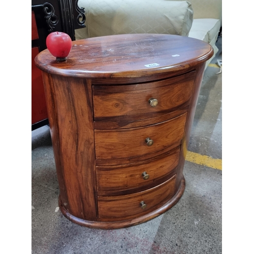 410 - A very elegant and heavy rose wood oval chest of drawers fitted with 4 drawers with delicate metal h... 