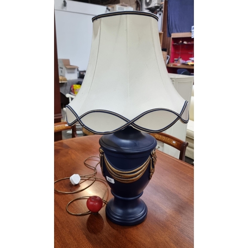 420 - A striking large table lamp with an urn base in shades of navy and gold. Topped with an elegant matc... 