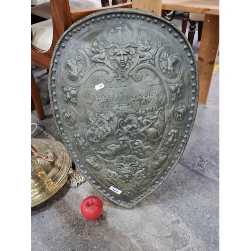 423 - Star Lot : An antique truely stunning very detailed brass shield depicting a battle scene to centre.... 