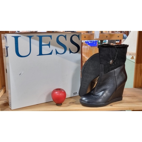 424 - A pair of Guess black wedged ankle boots with black faux fur lining. Size EU 41. In as new condition... 