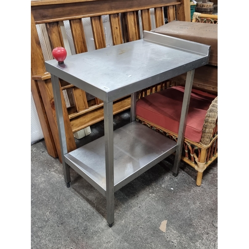 432 - A high quality stainless steel catering table with gallery back.