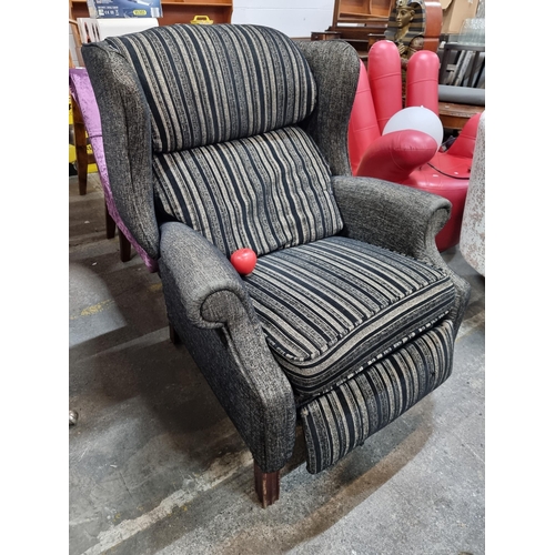 441 - A highly stylish comfortable wing backed armchair.