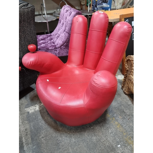 454 - Star Lot : A very unusual eye catching designer red leather chair in the form of a hand.