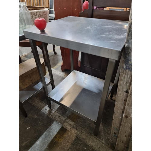 470 - A commercial grade steel kitchen island with lower tier to base. Commercial quality from a recently ... 