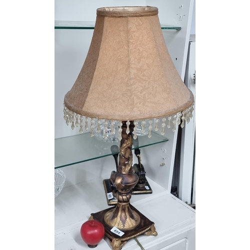 494 - A very stylish Rococo style table lamp with a drop lit shade.