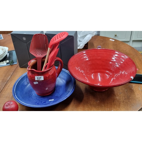 537 - A stunningly large terracotta fruit bowl in a vibrant red along with a large matching pitcher jug, u... 