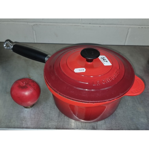 547 - A Le Creuset cast iron 2.5L lidded pot with long handle. In a red finish.