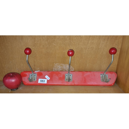 553 - A Mid Century wall coat hanger featuring three hooks. In a vibrant red finish.