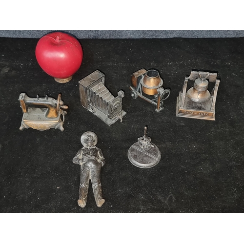 557 - A selection of 6 items  unusual pencil sharpeners in the form of a sewing machine, camera, bell and ... 