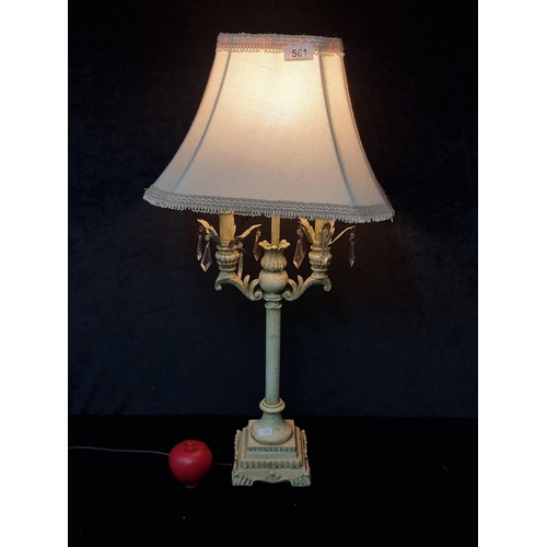 561 - A Neoclassical style table lamp with an intricate base featuring fleur de lis motif and an attractiv... 