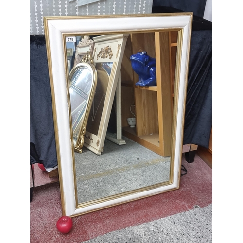 578 - A heavy cream and gilt frame mirror. Glass in good condition.